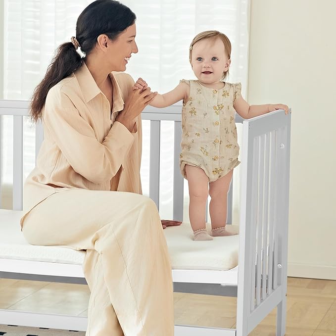 MAMAZING EvoNest Baby Crib, 11 in 1 Convertible Mini Crib with Wheels, 100% New Zealand Wood Growing Bed, 4 Adjustable Mattress Height, White