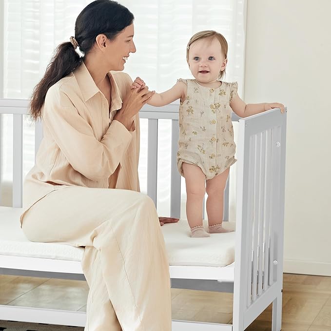 MAMAZING EvoNest Baby Crib, 6 in 1 Convertible Mini Crib with Wheels, 100% New Zealand Wood Growing Bed, 4 Adjustable Mattress Height, GREENGUARD Gold Certified, White