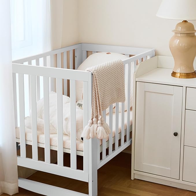 MAMAZING EvoNest Baby Crib, 11 in 1 Convertible Mini Crib with Wheels, 100% New Zealand Wood Growing Bed, 4 Adjustable Mattress Height, White
