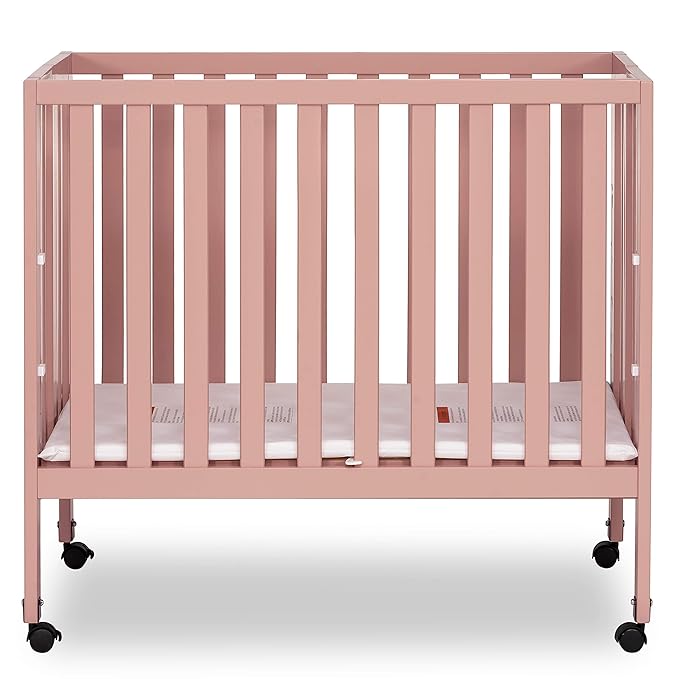 Dream On Me Jett Mini Folding Baby Crib in Dusty Pink, GreenGuard Gold & JPMA, Lightweight & Portable, Patented Flat Folding System for Small Spaces & Travel, 1.5” Mattress Pad, 3 Heights, Safe Wheels