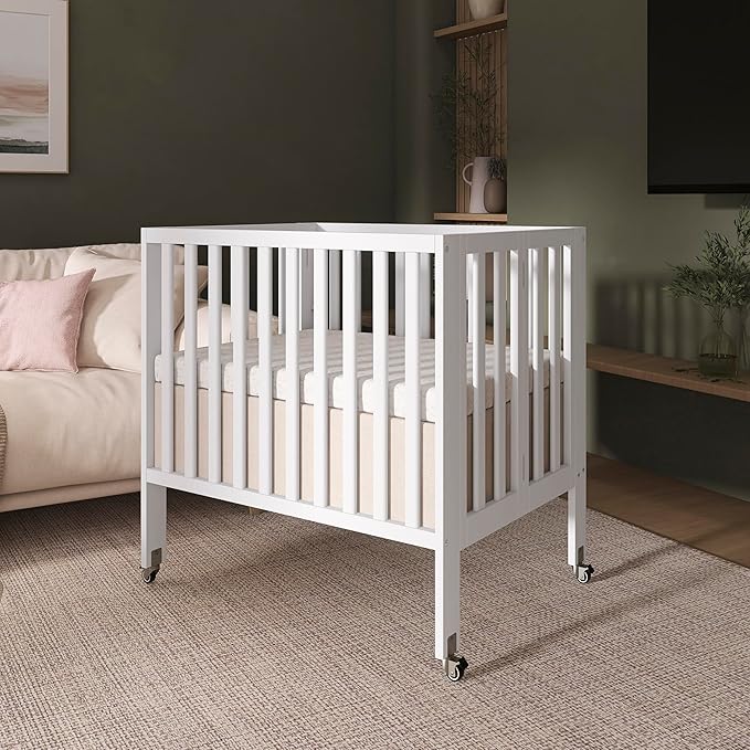 Dream On Me Jett Mini Folding Baby Crib in White, GreenGuard Gold & JPMA, Lightweight & Portable, Patented Flat Folding System for Small Spaces & Travel, 1.5” Mattress Pad, 3 Heights, Safe Wheels